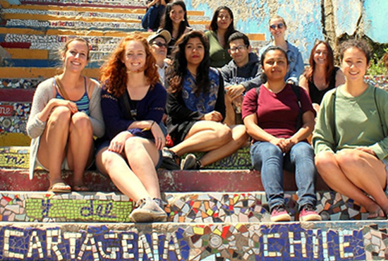 Literature students from UC San Diego sitting on steps in South America