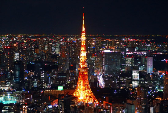 Tokyo, Japan - overlooking the city lights at night, with Tokyo Tower in center of image - photo by Yu Kato, unsplash.com/@yukato
